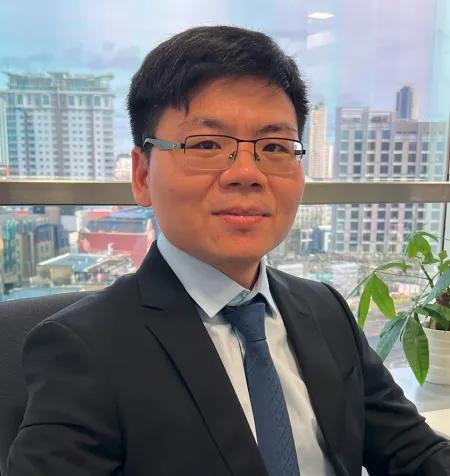 Dr Wenfeng Xia, a man in a suit with glasses